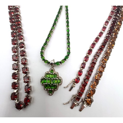 539 - A silver coloured metal and red stone necklace, a similar green stone necklace and pendant, and thre... 