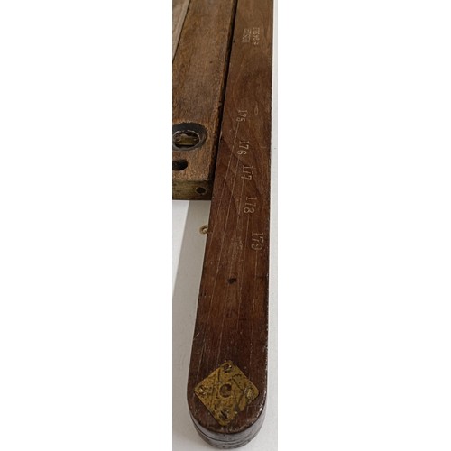 1182 - A folding measure, two spirit levels, a carved set of bellows and assorted walking sticks