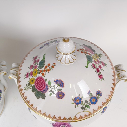 1164 - A pair of Dresden tureens and covers, decorated flowers and highlighted in gilt, 30 cm diameter