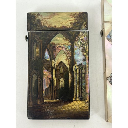 1236 - A 19th century lacquered card case, decorated ruin, and a mother of pearl card case (2)