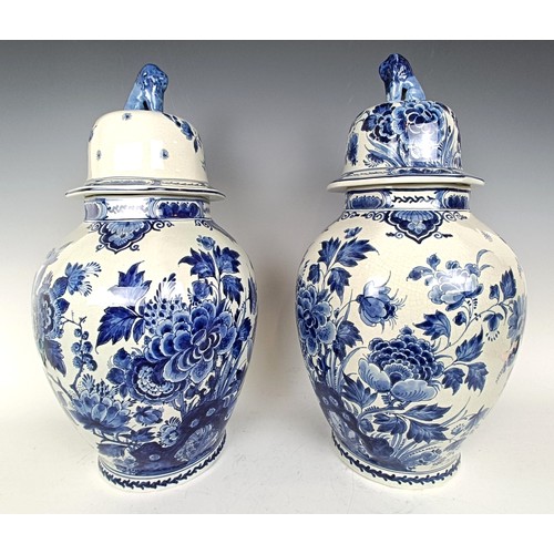 1103 - A near pair of blue and white delft vases and covers 55 cm high (2)