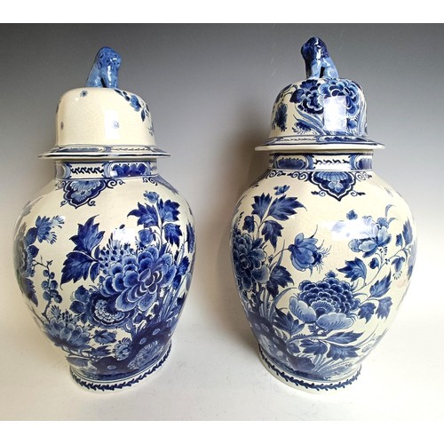 1103 - A near pair of blue and white delft vases and covers 55 cm high (2)...