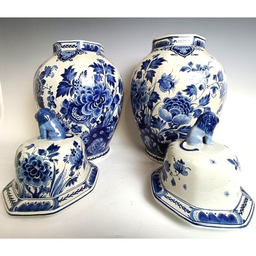 1103 - A near pair of blue and white delft vases and covers 55 cm high (2)