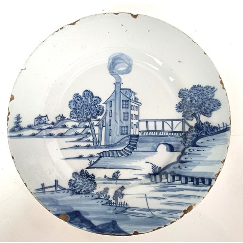 1114 - A Delft plate, decorated a mill by a bridge, 22 cm diameter, and a set of brass postal scales (2)...