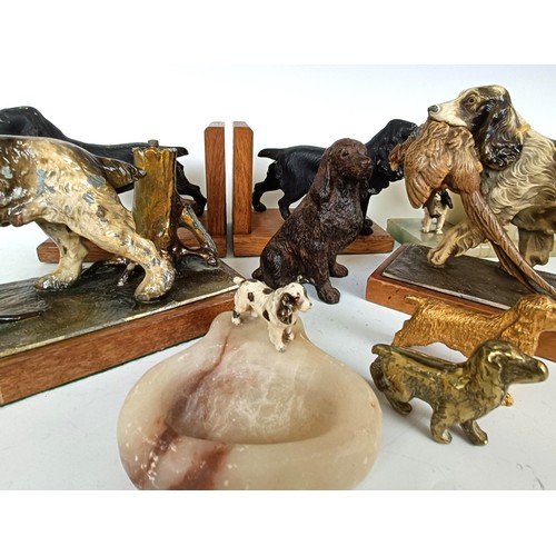 1157 - A novelty table lighter, in the form of a spaniel holding a pheasant, a pair of spaniel bookends, a ...