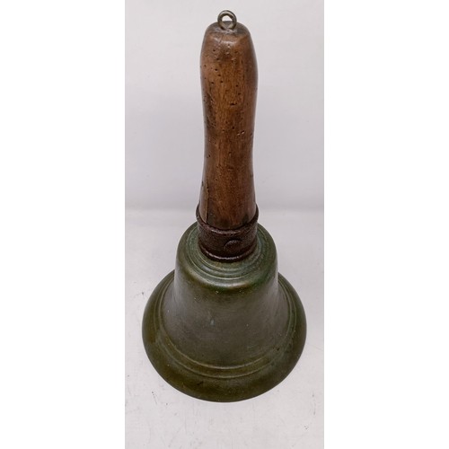 1260 - A large bronze bell, with a wooden handle, 36 cm high