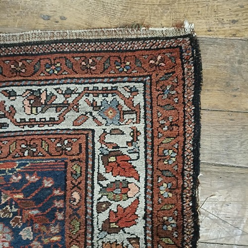 1287 - A Persian red ground rug, 200 x 112 cm