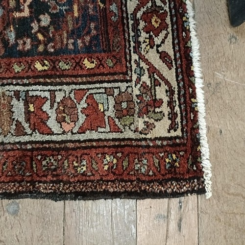 1287 - A Persian red ground rug, 200 x 112 cm