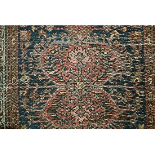 1287 - A Persian red ground rug, 200 x 112 cm