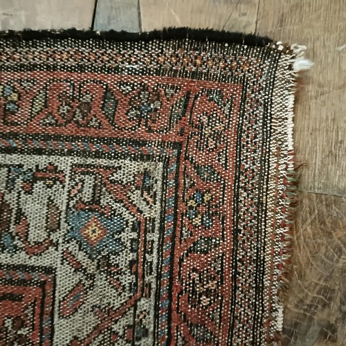 1287 - A Persian red ground rug, 200 x 112 cm