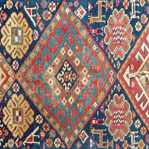 1288 - A Caucasian red ground rug, 245 x 108 cm