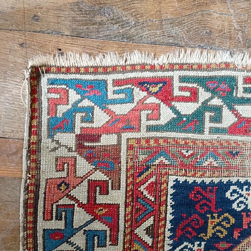 1288 - A Caucasian red ground rug, 245 x 108 cm