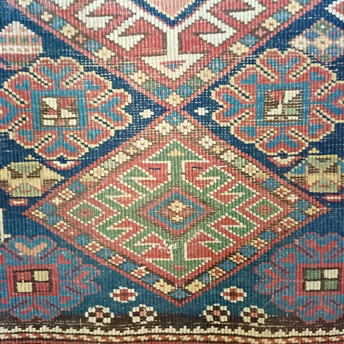 1288 - A Caucasian red ground rug, 245 x 108 cm