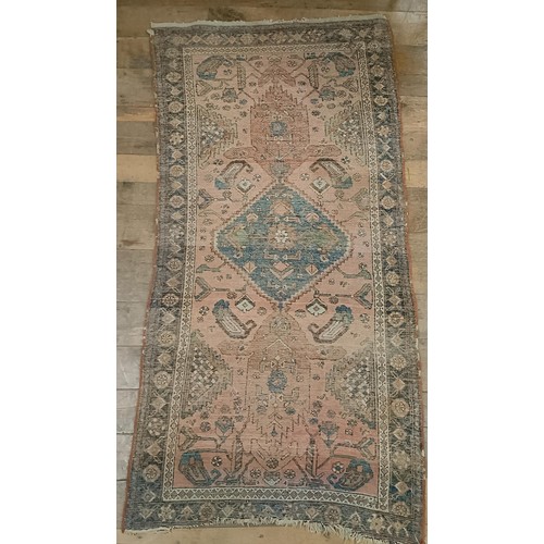 1309 - A Persian salmon pink ground rug, 202 x 98 cm