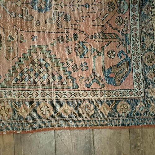 1309 - A Persian salmon pink ground rug, 202 x 98 cm