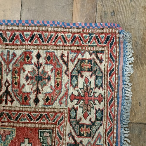 1312 - A Kazak red ground rug , 172 X 134 cm