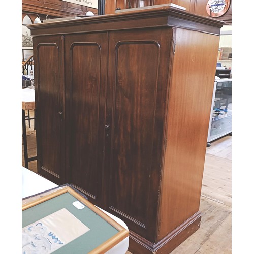 1359 - A mahogany compactum, having three cupboard doors, to reveal slides and drawers, 143 cm high x 140 c... 