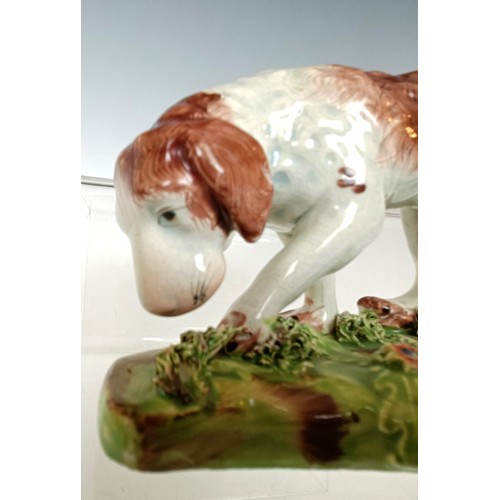 1249 - A 19th century Staffordshire hound dog, 10.5 cm high