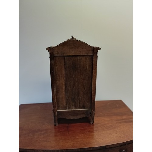 1330 - A late 19th/early 20th century apprentice or miniature armoire, with a single mirrored door, carved ... 