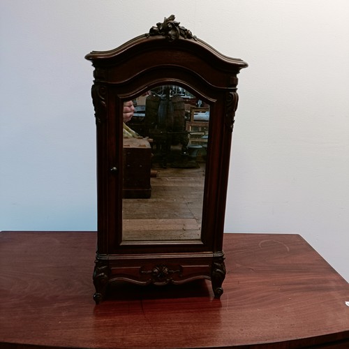 1330 - A late 19th/early 20th century apprentice or miniature armoire, with a single mirrored door, carved ... 