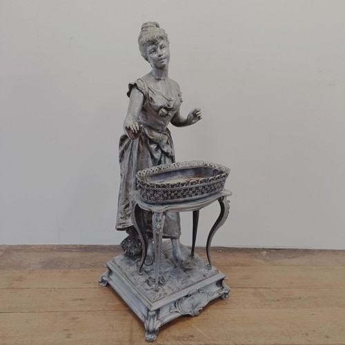 1298 - A large spelter figure of a lady in front of a table, on a square base, 100 cm high