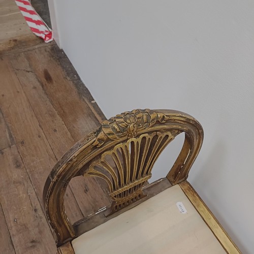 1283 - An early 20th century gilt window seat, with pierced ends, on reeded tapering legs, 86 cm wide