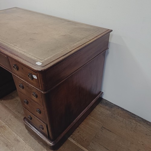 1285 - A mahogany pedestal desk, having nine drawers, 128 cm wide