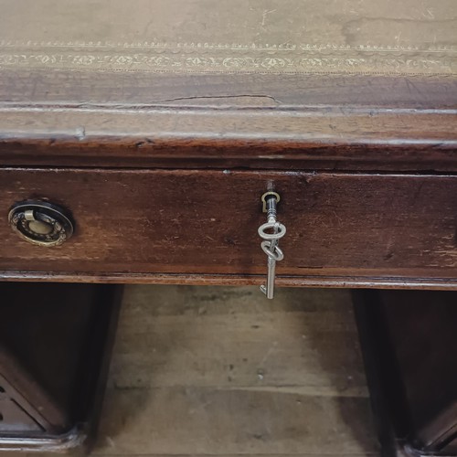 1285 - A mahogany pedestal desk, having nine drawers, 128 cm wide