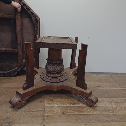 1316 - A Victorian carved oak octagonal library table, on a carved column support to a shaped base, 140 cm ... 