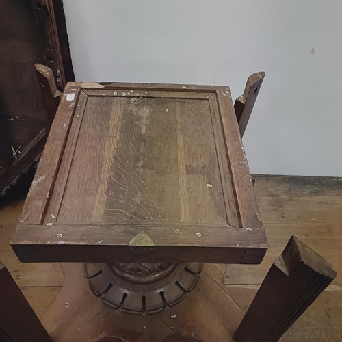 1316 - A Victorian carved oak octagonal library table, on a carved column support to a shaped base, 140 cm ... 