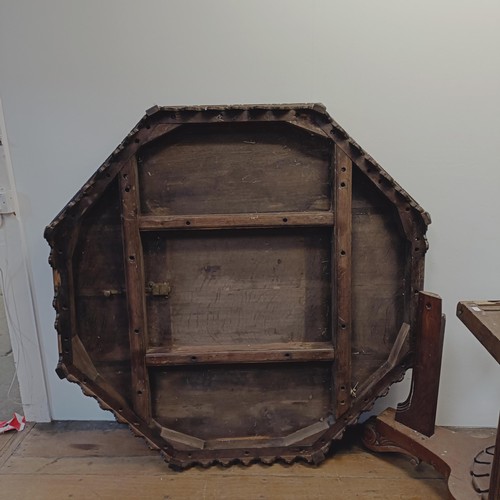 1316 - A Victorian carved oak octagonal library table, on a carved column support to a shaped base, 140 cm ... 