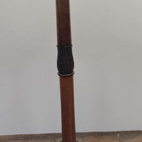 1353 - A carved walnut standard lamp, 136 cm high