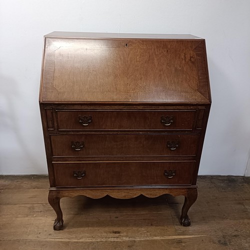 1318 - A mahogany bureau, 76 cm wide, an armchair and a standard lamp (3)