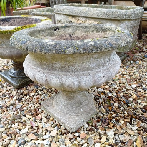 1443 - A composite stone circular planter, and another similar (2)...