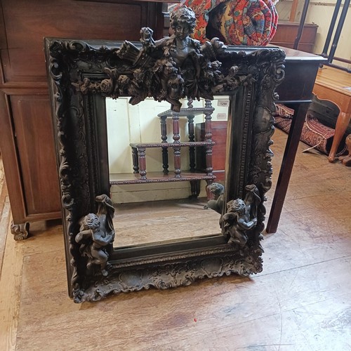 1299 - A rococo style wall mirror, decorated cherubs, 90 x 60 cm