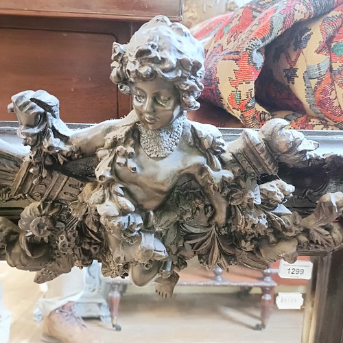 1299 - A rococo style wall mirror, decorated cherubs, 90 x 60 cm