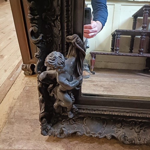 1299 - A rococo style wall mirror, decorated cherubs, 90 x 60 cm