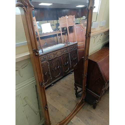 1375 - A large and impressive Continental walnut mirror, the cornice painted cherubs, carved foliate forms,... 