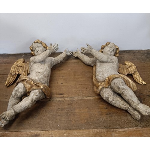 1324 - A large pair of carved and painted cherubs, 76 cm high x 46 cm wide (2)