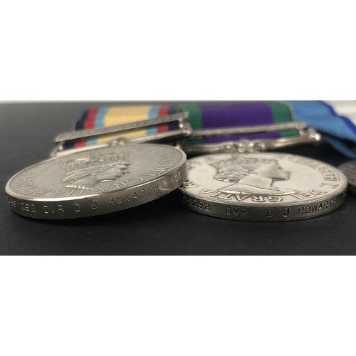 128 - A group of three medals, awarded to 24891292 Dvr D J Howarth RCT, comprising an Iraq medal, with 16 ... 