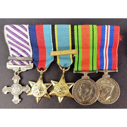 277 - A group of seven miniature medals, including a Distinguished Service Cross (DSC), and other assorted... 