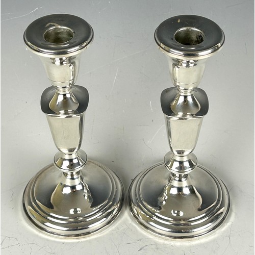 1801 - A pair of sterling silver candlesticks, 19 cm high and a silver coloured metal salt and pepper, in a... 