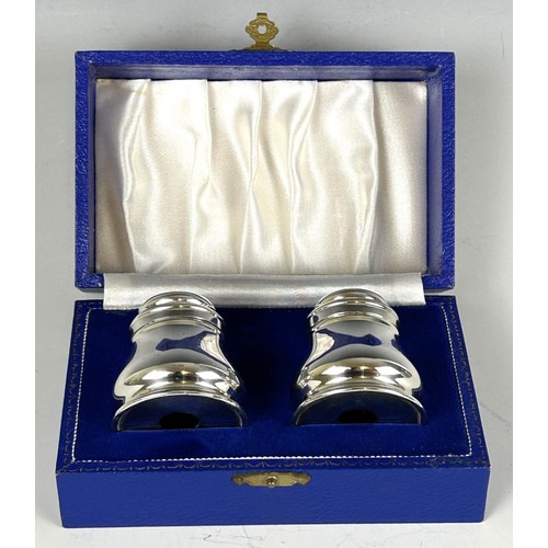 1801 - A pair of sterling silver candlesticks, 19 cm high and a silver coloured metal salt and pepper, in a... 