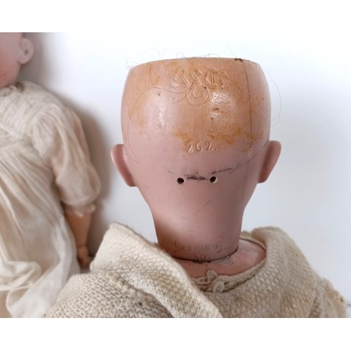 900 - An Armand Marseille bisque head doll, with a jointed body, and glass millefiori eyes, No 390, 74 cm ... 