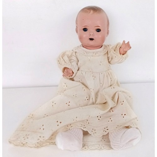 902 - A Continental bisque head doll, with a jointed body, with closing millefiori eyes, 52 cm and two bab... 