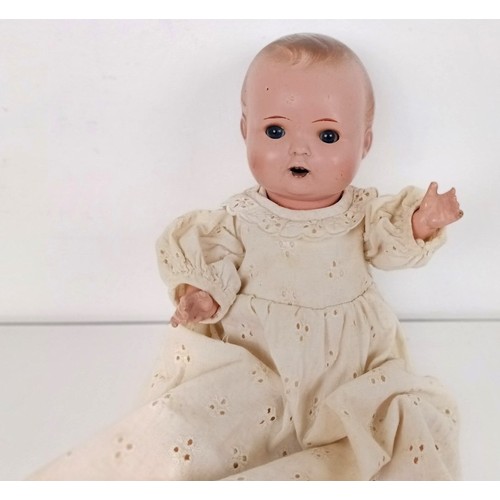 902 - A Continental bisque head doll, with a jointed body, with closing millefiori eyes, 52 cm and two bab... 