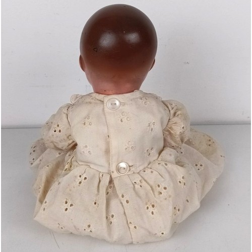 902 - A Continental bisque head doll, with a jointed body, with closing millefiori eyes, 52 cm and two bab... 