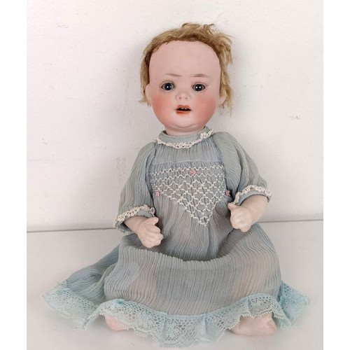 902 - A Continental bisque head doll, with a jointed body, with closing millefiori eyes, 52 cm and two bab... 