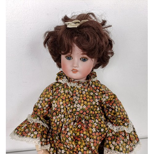 905 - A German Simon & Halbig bisque head doll, with a jointed body, and closing millefiori eyes, 48 c... 