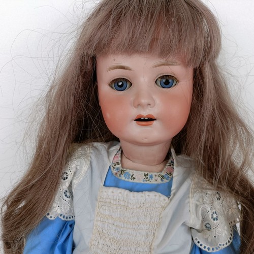 906 - A Heubach bisque head doll, with millefiori eyes, and a jointed body, No 250.7, 73 cm high  Provenan... 